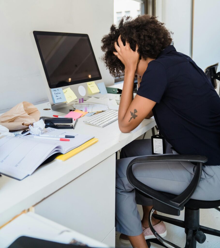 Frustrated Woman Sitting by Desk